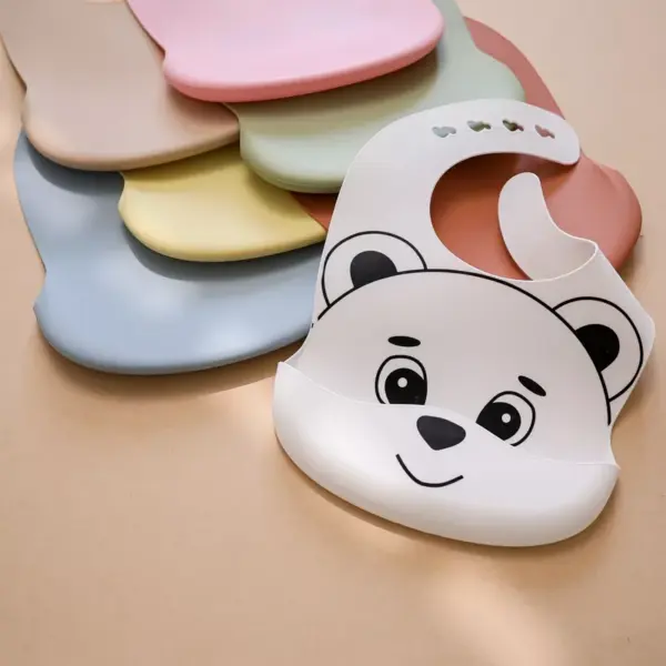 100475-5ddb26.webp Adjustable Silicone Baby Bib with Crumb Catcher and Cute Bear Design